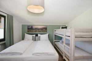 a bedroom with two bunk beds and a lamp at Chalet Zeller Moos in Zell am See