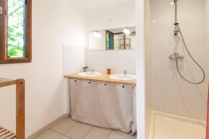 a bathroom with two sinks and a shower at Case di Mare Chalet Bignone in Cervione +28 photos