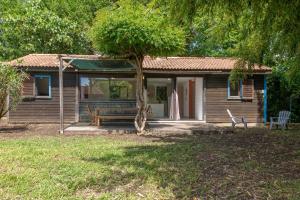 a small house with a bench and a tree at Case di Mare Chalet Bignone in Cervione