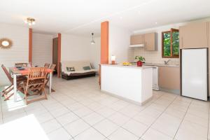 a kitchen and living room with a table and a kitchen and a dining room at Case di Mare Chalet Bignone in Cervione