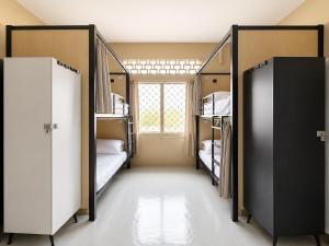 a room with three bunk beds and a window at Astrid Lofts in Ipoh
