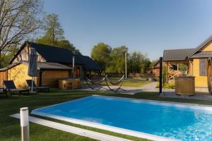 a swimming pool in the yard of a house at Mościce Dolne 69 in Nowosiółki