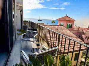a balcony with a view of the ocean at Luxury Sofi in Giardini Naxos