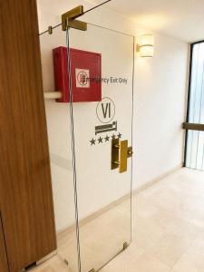 a glass door with a sign on it in a room at The Square Central Prishtina in Prishtinë +16 photos