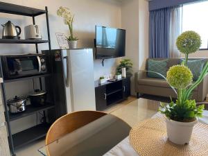 a living room with a refrigerator and a table at R2 condotel tower in Manila