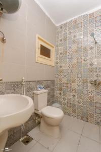 a bathroom with a toilet and a sink at Home Hotel Dahab in Dahab +83 photos