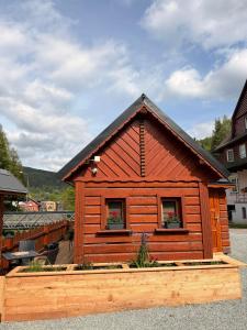 a small wooden cabin with two windows and a roof at Chalupa Javořinka in Pec pod Sněžkou