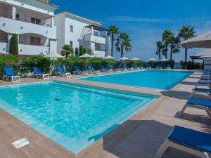 a swimming pool in front of a building at L'Escapade Corse - À 80 mètres de la plage in San-Nicolao