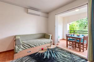 a living room with a couch and a table at L'Escapade Corse - À 80 mètres de la plage in San-Nicolao +10 photos