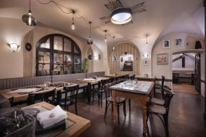 a restaurant with tables and chairs in a room at U Schnellu in Prague