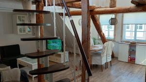 a living room with a spiral staircase in a house at Eulen- & Altstadtnest in Peine