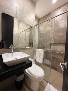 a bathroom with a sink and a toilet and a shower at Palmará Hotel in Villeta +21 photos