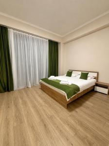 a bedroom with a bed and a large window at N4 Alvina Complex in Tsaghkadzor