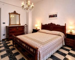 a bedroom with a large bed and a mirror at Sea View Apartment - Private Parking AC in Savona