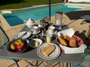 a table with a tray of breakfast food on it at Moulin de Bas Couleur in Villedômer