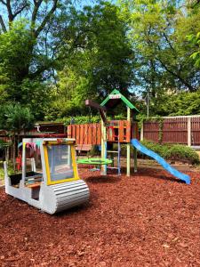a playground with a slide and a play equipment at Ferienhaus an den Eichen in Aschersleben