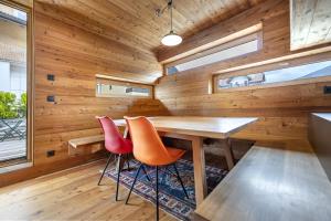 a dining room with wooden walls and a wooden table and chairs at Design Lodge The Cube in Ortisei
