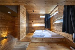 a large wooden room with a bed in it at Design Lodge The Cube in Ortisei