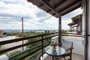 a balcony with a table and a view of the ocean at Apartment with sea view - Creta in Ferma