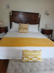a bedroom with a large bed with a wooden headboard at Casa Rural in Esposende