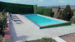 a large swimming pool with chairs on a patio at Crama Diaconu in Anenii Noi