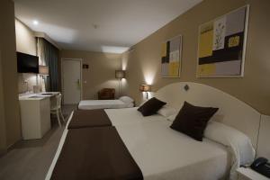 Postel nebo postele na pokoji v ubytování Hotel Torico Plaza + 37 fotografií