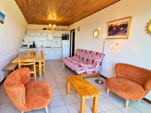 a living room with a couch and a table and chairs at Grand appartement pour 12 pers. avec balcon sud, WIFI, parking et proche pistes – St Michel de Chaillol - FR-1-393-11 in Saint-Michel-de-Chaillol +14 photos