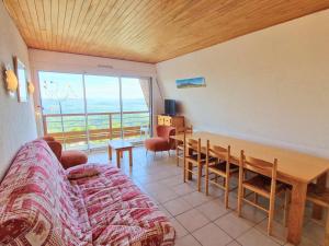 a living room with a couch and a table with a view at Grand appartement pour 12 pers. avec balcon sud, WIFI, parking et proche pistes – St Michel de Chaillol - FR-1-393-11 in Saint-Michel-de-Chaillol