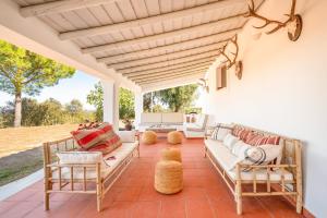 an outdoor living room with a couch and chairs at Authentic Alentejo Farmhouse in Arraiolos
