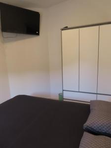 a bedroom with a bed and a tv on a wall at Bellavista in Strožanac
