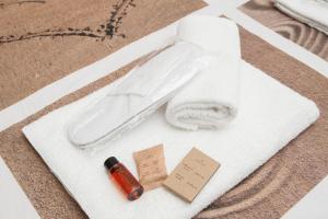a toilet bowl with a bottle of soap and a tag at Magia in Trastevere in Rome +47 photos
