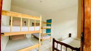 a room with two bunk beds and a ladder at Hostel Agatha in Paraty