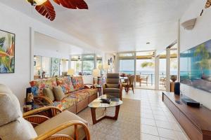 a living room with a couch and a table at Flip Flops & Sand Beach house in Wells