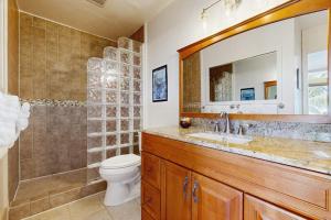 a bathroom with a toilet and a sink and a mirror at Flip Flops & Sand Beach house in Wells +22 photos