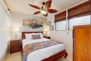 a bedroom with a bed and a ceiling fan at Flip Flops & Sand Beach house in Wells
