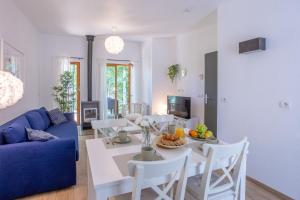 a living room with a table and a blue couch at Les Charmes C10 - Le Val Joly in Eppe-Sauvage