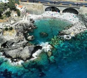 an aerial view of a body of water with a bridge at Natura e relax in Anzo +8 photos