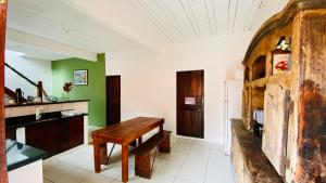 a kitchen with a wooden table and green walls at Hostel Agatha in Paraty +10 photos