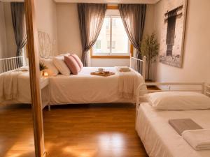 a bedroom with two beds and a mirror at Villa María Arrecife Beach in Arrecife