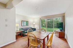 a living room with a table and chairs and a couch at Seasons 208 in Warren