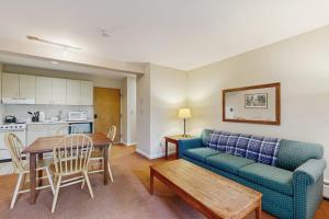 a living room with a couch and a table at Seasons 208 in Warren +9 photos