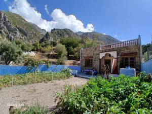 a house with a mountain in the background at Smart House in Chefchaouen