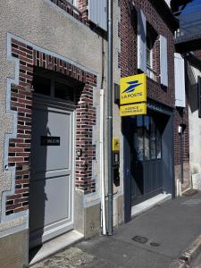 a building with a door and a sign in front of it at Le Balcon in Frazé