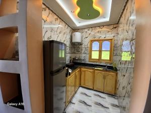 a kitchen with wooden cabinets and a refrigerator at Smart House in Chefchaouen