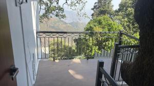 a balcony with a view of a mountain at The Kumaon Retreat in Nainital