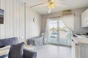 a kitchen with a table and chairs and a balcony at Salty Breeze Studio in Wells