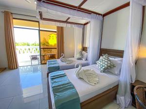 two beds in a room with a balcony at The Safiya Hotel, Diani Beach, "Formely Diani Palm Resort" in Diani Beach +110 photos