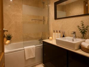 a bathroom with a sink and a shower and a tub at Villa María Arrecife Beach in Arrecife +9 photos