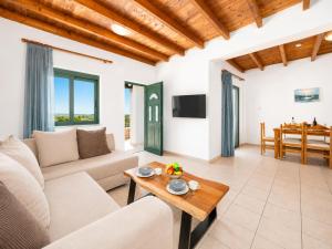 a living room with a couch and a table at Andreas Beach Villa in Sfakia