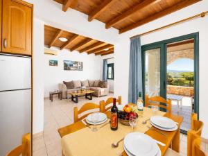 a kitchen and a dining room with a table and chairs at Andreas Beach Villa in Sfakia